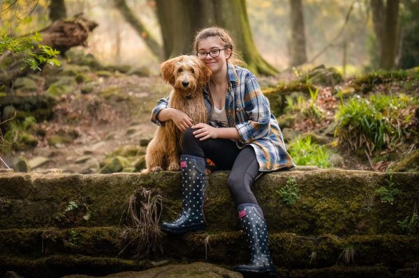 A Goldendoodle puppy with their owner during a pet photography session near Harrogate